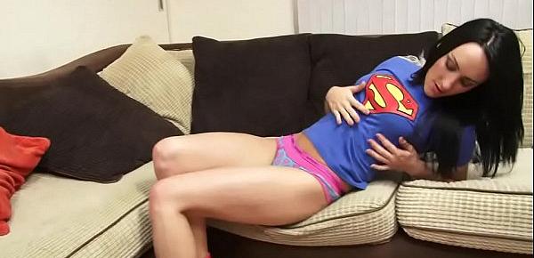  Brunette in superman tshirt finger fucks herself on the sofa